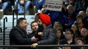 A Sikh protester is removed from a Trump rally.